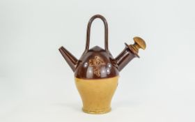 Earthenware Vessel Unusual cream and brown glazed vessel with handle, spout and carved wood stopper.