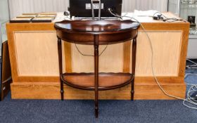 Console Table Dark wood semi circular table with semi circular bottom stretcher.