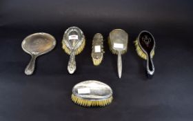 Collection of Silver Backed Brushes and Mirror, comprising three dressing table hair brushes,