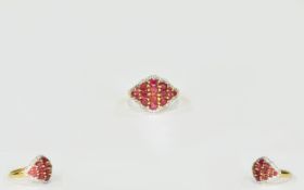 Ruby and White Topaz Cluster Ring, oval and round cut rubies set in a scalloped diamond shape,