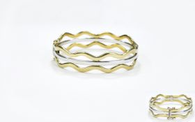 Ladies Two Tone White and Yellow Gold Hinged Bangle. c.1980's. Marked 375 - 9ct.