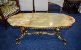 Green Onyx Coffee Table Ornate brass framed lozenge shaped table with reticulated apron.