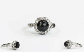 Black Star Diopside and Diamond Ring, a round cut cabochon of black diopside displaying asterism,