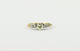 18ct Gold Set Single Diamond Ring with Six Small Diamonds to Shoulders. Diamond of Good Colour.