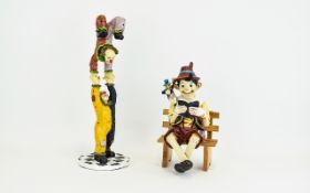 Pinnochio Resin Figure A whimsical figure of pinnochio and Jiminey Cricket reading whilst seated on