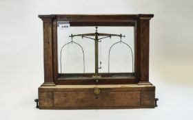 Glass cases lab scales, dating from the late 19th Century or early 20th Century.