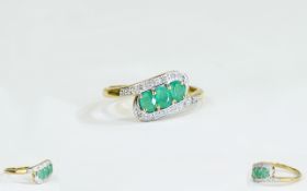 9ct Gold Dress Ring Set With 3 Central Emeralds Between Round Cut Diamonds Shoulders.