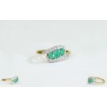 9ct Gold Dress Ring Set With 3 Central Emeralds Between Round Cut Diamonds Shoulders.