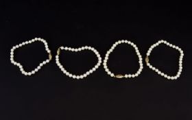 Cultured Pearl Bracelet Four strand bracelet with individual gold closures.