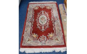 Oriental Style Rug Small rectangular rug in russet tones with oriental floral repeat pattern and