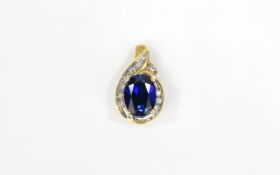 9ct Gold Sapphire And Diamond Pendant Oval Faceted Blue Sapphire Surrounded By Round Cut Diamonds.