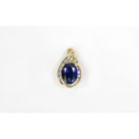 9ct Gold Sapphire And Diamond Pendant Oval Faceted Blue Sapphire Surrounded By Round Cut Diamonds.