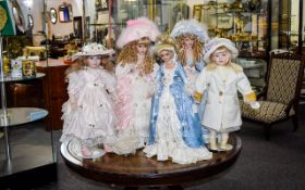 A Collection Of Porcelain Collectors Dolls Five in total, each with individual stand.
