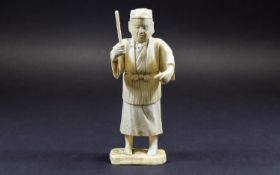 Chinese Ivory Figure of a Man about to hit a fish with a stick; mounted on a bone base; 6 inches