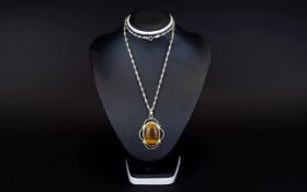 Silver And Tigers Eye Pendant Long fancy silver chain with large oval pendant set in silver