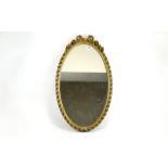 Mirror Oval mirror in dark gilt frame wi