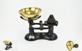 Vintage Kitchen Scales Black cast iron scales with brass weighing pan and six imperial weights.