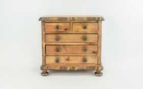 A Small Apprentice Table Top Chest of Drawers In Stained Wood.