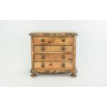 A Small Apprentice Table Top Chest of Drawers In Stained Wood.