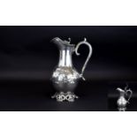 A 19th Century White Metal / Silver Plated Lidded Claret Water Jug with Scrolled Floral Decoration