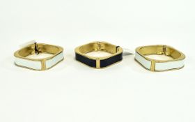 Hinged Statement Bangles Set of three gold tone metal hinged bangles with faux leather central