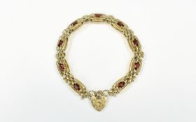 A Nice Quality 9ct Gold Panther Bracelet, Set with Nine ( 9 ) Faceted Garnets with Attached Fancy