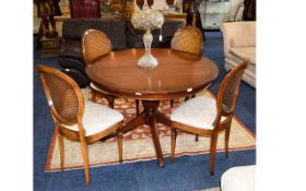 Large Multi Fuctional Dining Table Dark wood raised on a turned column with quatrefoil legs.