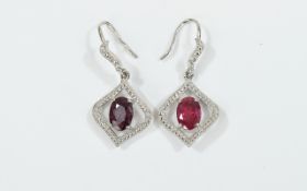 Pair of Ruby Pendant Earrings, each earring comprising an oval cut solitaire ruby, of over 1ct,