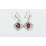 Pair of Ruby Pendant Earrings, each earring comprising an oval cut solitaire ruby, of over 1ct,