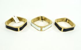 Hinged Statement Bangles Set of three gold tone metal hinged bangles with faux leather central