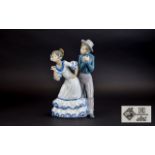 Nao By LLadro Figure Depicts a young girl and boy engaged in animated pose in traditional flamenco