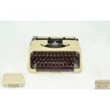 Vintage Olympia Splendid 33 Typewriter Portable typewriter in original cream plastic carry case.