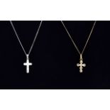 Two Gold Crucifix Pendant and Chain Necklaces comprising one white and one yellow gold.
