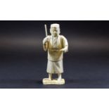 Chinese Ivory Figure of a Man about to hit a fish with a stick; mounted on a bone base;