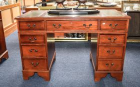 Writing Desk Large 9 drawer desk with central green leather and gilt tooled inlay to top.