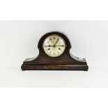 Mahogany Cased Helmet Shaped Mantle Clock with silvered dial and Arabic Numerals.