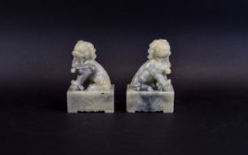 Pair Of Chinese Alabaster Foo Dogs/Fu Lions Raised On Squre Plinths,