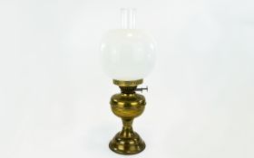 Brass Oil Lamp Of plain form with inner glass tube and removable outer glass globe shade.