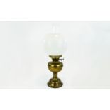 Brass Oil Lamp Of plain form with inner glass tube and removable outer glass globe shade.