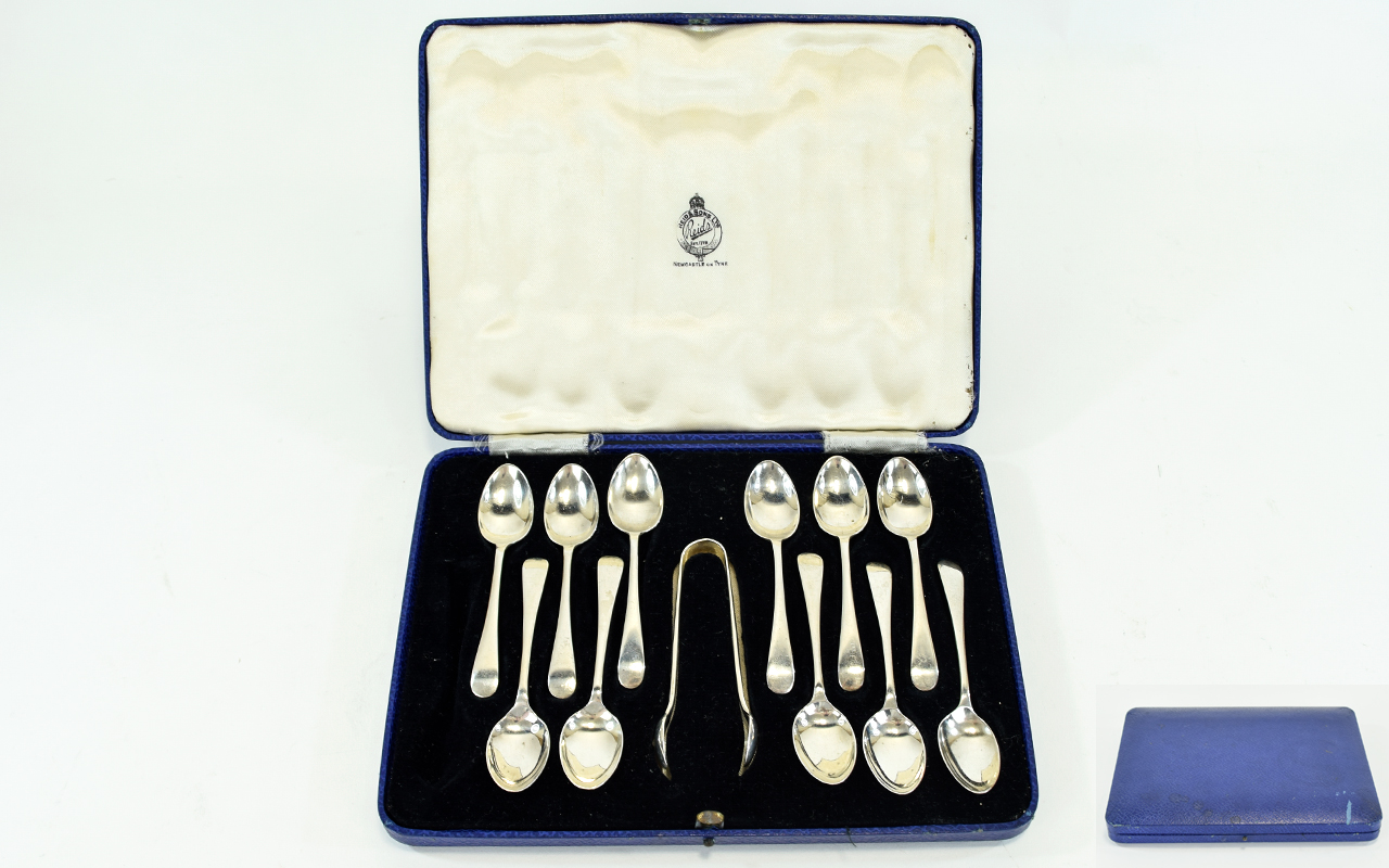 A Boxed Set of ( 11 ) Eleven Teaspoons and Matching Sugar Tongs In Solid Silver.