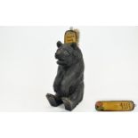 A Black Forest Carved Bear with a brush holder and glass eyes. 8.