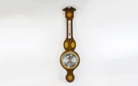 Barometer Wall mounted barometer housed in inlaid wood surround, silver tone dial, approx length 33.