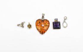 A Large Heart Shaped Amber Set Pendant. Fully Hallmarked + Four Silver Set Small Pendants.