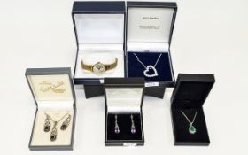 Four Boxed Items of Silver Jewellery comprising heart pendant, pendant and earring set, green gem