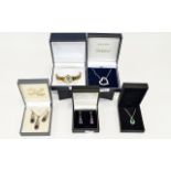 Four Boxed Items of Silver Jewellery comprising heart pendant, pendant and earring set, green gem