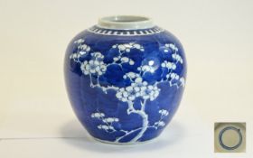 Chinese 19th Century Kangxi Globular Shaped Blue and White Jar with Prunus Decoration on Blue