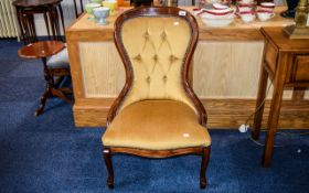 Bedroom Chair Antique dark wood low chair with button back and pale gold velour upholstery.