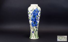 Moorcroft Tall and Impressive Tubelined Modern Vase 'Delphinium' design on white ground.