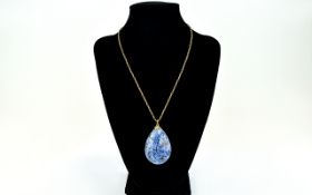 A Scottish Blue Pebble Mounted On A 9ct Gold Chain