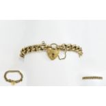 A 1950's Nice Quality 9ct Gold Curb Bracelet with attached heart shaped padlock and safety chain.